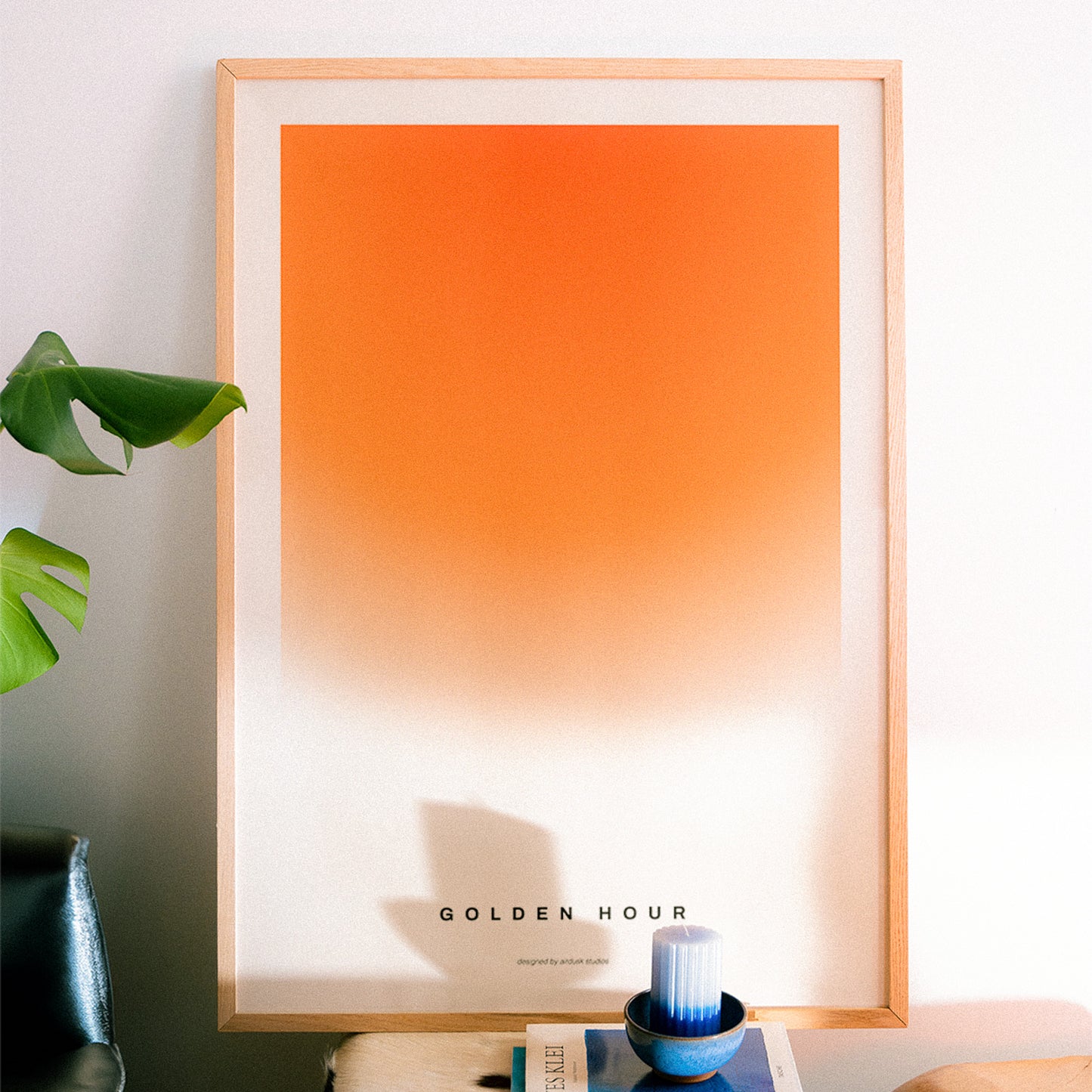 Minimal poster art home decor with text "GOLDEN HOUR" alongside a warm gradient portraying a sunset in a midcentury modern / retro design.