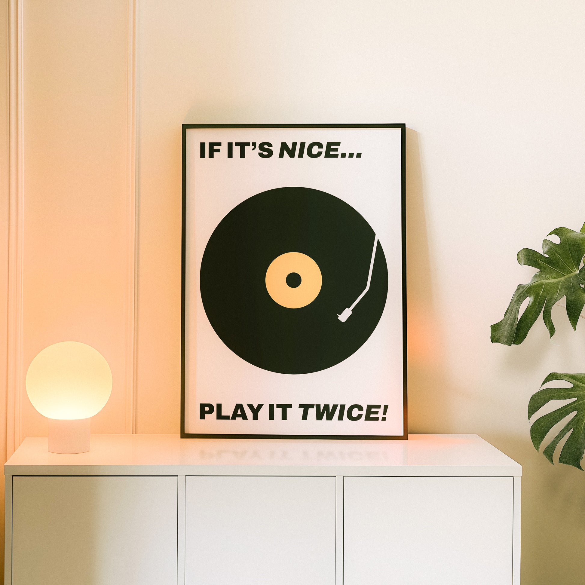 Typography music poster home decor with text "If it's nice...play it twice" in a minimal, retro, and midcentury modern design.